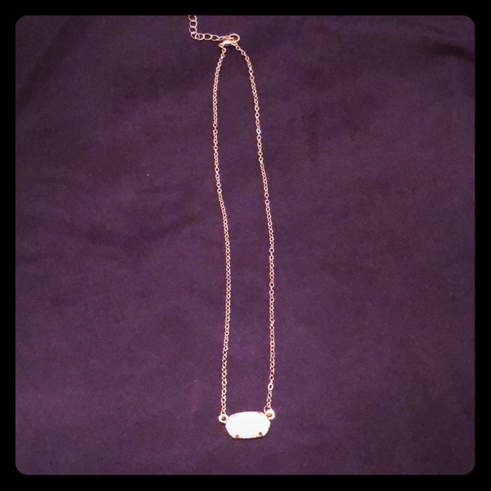 Gold necklace with white stone